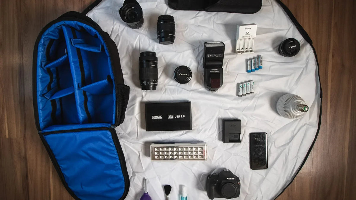Camera gear and accessories laid out on a bag insert – camera gifts under $50 for photographers